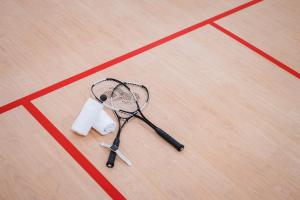 a tennis racket and a roll of tape on a court at Oceanfront Beach Resort - SHA Extra Plus in Patong Beach
