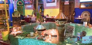 a table in a restaurant with a table with a lamp at Riad Dia in Marrakesh