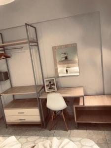 a bedroom with a desk and a mirror and a chair at Aloni Studios and Apartments in Lassi