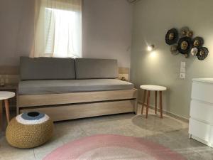a room with a bed with two tables and a window at Aloni Studios and Apartments in Lassi