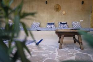 a couch with blue and white pillows and a table at Ronda Center Apartments with Pool in Ronda