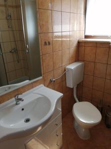 a bathroom with a white sink and a toilet at Christian in Mali Lošinj