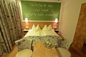 a hotel room with a bed and a plate of food on a table at Hotel-Restaurant Forellenhof in Puchberg am Schneeberg