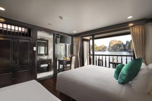 a bedroom with a bed and a view of the water at Alisa Cruise Halong in Ha Long +51 photos