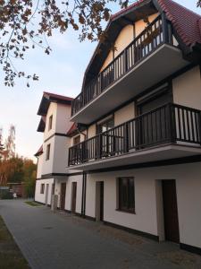 a building with balconies on the side of it at Rowy Apartament.b5 in Rowy