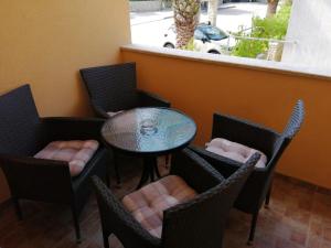 a table and chairs with a table and a window at Christian in Mali Lošinj