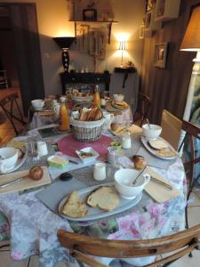 a table with plates of food on top of it at Villa Des Hortensias in Paimpol