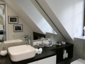 a bathroom with a sink and a mirror at Euforia Apartamenty in Kazimierz Dolny