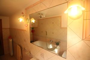 a bathroom with a tub and a sink and a mirror at Casa Mary in Lucca +31 photos