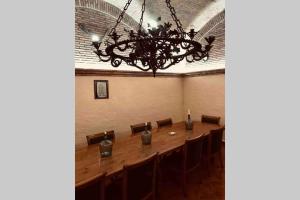 a dining room with a large table and a chandelier at Chalet Individual con bodega, en el corazón de La Rioja in Gimileo +35 photos