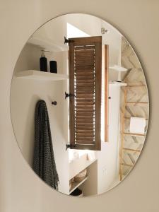 a mirror hanging on a wall in a bathroom at Ronda Center Apartments with Pool in Ronda