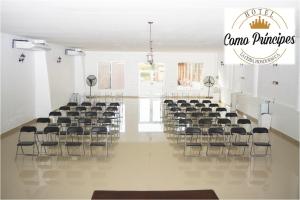 a room with rows of chairs in a room at Hotel Como Principes in La Ceiba