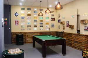 a room with a pool table and pictures on the wall at Hotel Terra Preta in Ibiúna