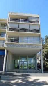 a building with a sign on the front of it at FerPilar Suite, Concord Pilar in Pilar