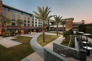 a large building with palm trees in a courtyard at Viejas Casino & Willows Hotel in Alpine