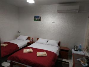 a hotel room with two beds with towels on them at Мотель "КАЛИНА" in Yavoriv