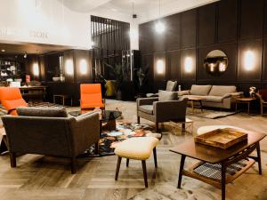a lobby with couches and chairs in a store at Getaway Studios Gent in Ghent