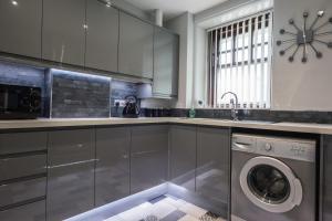 a kitchen with a washer and dryer on the floor at Spey Courtyard in Perth