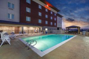 a hotel swimming pool in front of a hotel at Hawthorn Extended Stay by Wyndham Odessa in Odessa