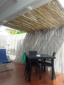 a black table and chairs on a patio at La Casa di Titina in Procida