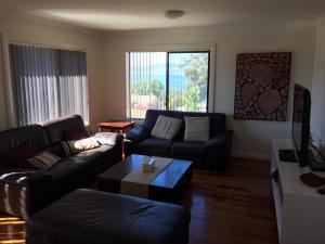 a living room with a couch and a coffee table at Lake Vista in Jindabyne