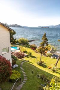 vistas a un patio con una casa y al océano en Sol del Nahuel - Hotel & Spa en San Carlos de Bariloche