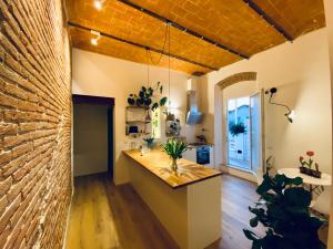 a kitchen with a counter and a brick wall at CivicoNovantatre - New b&b in San Vincenzo