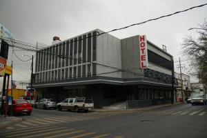 a man is sitting on the top of a building at Hotel HC Express in Monterrey