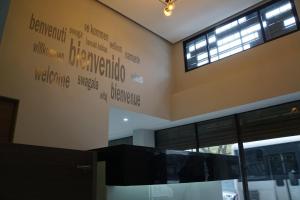 a wall with words on the side of a building at Hotel HC Express in Monterrey