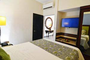 Postel nebo postele na pokoji v ubytování Hotel HBlue Centro