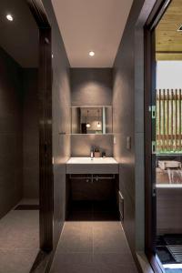a bathroom with a sink and a tub at Shiro Nozawa in Nozawa Onsen +73 photos