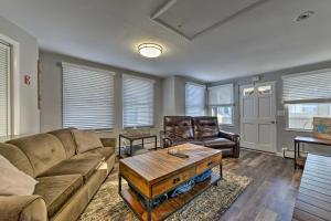 a living room with a couch and a table at Gulf Coast Cottage - Walk to Beach and Boardwalk! in Point Pleasant Beach