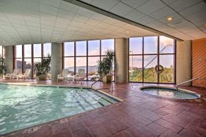 a large swimming pool in a building with windows at Cozy Retreat Less Than 4 Mi to Sugar Mountain Resort! in Sugar Mountain