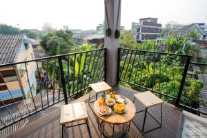 a plate of food on a table on a balcony at Le Neuf Nakorn Lampang in Lampang