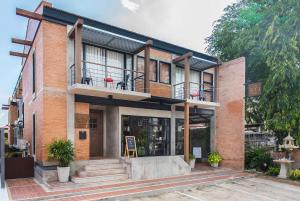 a brick building with a porch and a balcony at Sri Ayutthaya in Phra Nakhon Si Ayutthaya