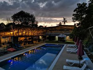 a resort with a swimming pool and a building at Bamboo Cottage Langkawi in Pantai Cenang
