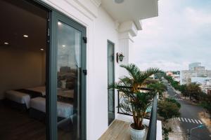 a room with a balcony with a view of a city at Royal Palms Hotel in Tuy Hoa