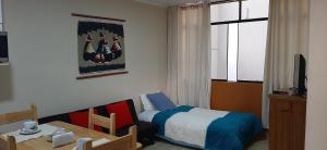 Postel nebo postele na pokoji v ubytování Huaraz Apartamentos