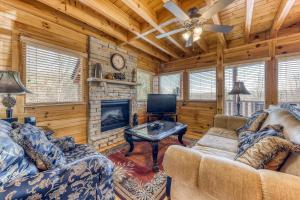 a living room with two couches and a fireplace at Always and Forever in Pigeon Forge