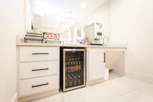 a kitchen with a refrigerator filled with drinks at Palace Inn Blue Federal Road in Houston +11 photos