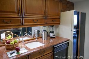 a kitchen with a sink and a refrigerator at WestgateAustin - Downtown Austin, Capitol Next Door, 30 Day Rental in Austin