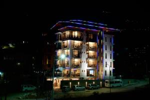 a tall building with lights on it at night at Hotel Ugyen, Thimphu in Thimphu