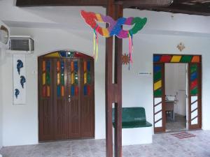 a room with a wooden door and a ladder at Pousada Bromelias Imbassai in Imbassai