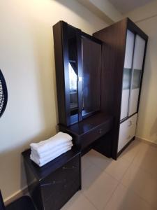 a bathroom with a black dresser and a mirror at Tanjung Tuan Regency Port Dickson 1 CarPark in Port Dickson +8 photos