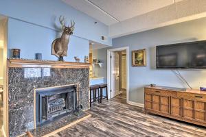 a living room with a fireplace and a tv at Cozy Retreat Less Than 4 Mi to Sugar Mountain Resort! in Sugar Mountain
