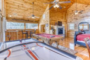 a room with a pool table and a bedroom at Always and Forever in Pigeon Forge