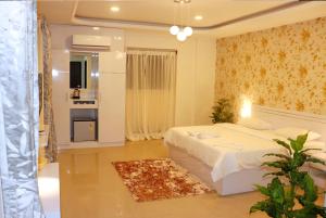 a bedroom with a white bed in a room at RK - Inn Premium Suites in Bengaluru +32 photos