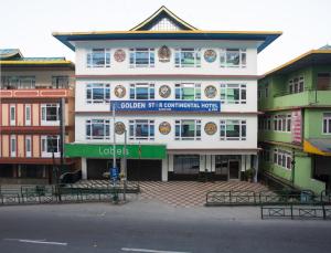 a large white building with a sign on it at Golden Star Continental & Spa in Gangtok