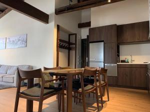 a kitchen and dining room with a table and chairs at Shiro Nozawa in Nozawa Onsen