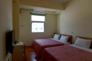 Postel nebo postele na pokoji v ubytování Light Time Homestay